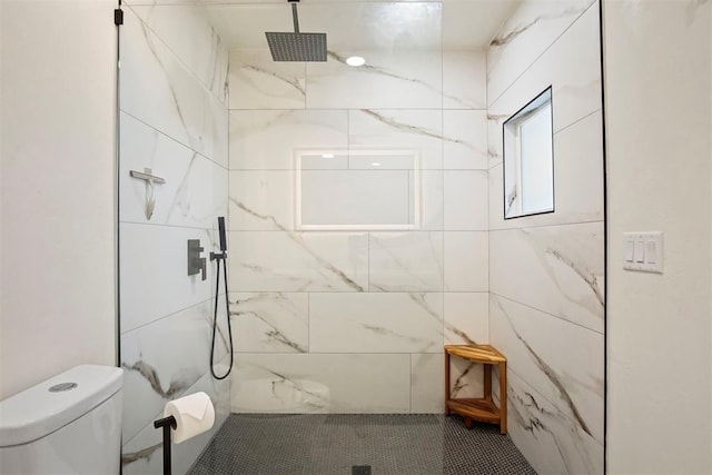 bathroom featuring toilet and tiled shower