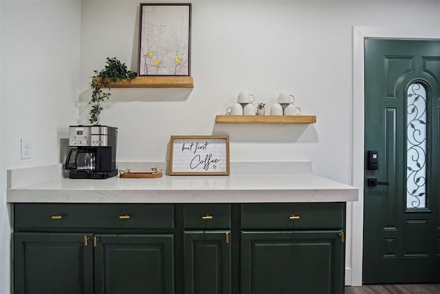 bar with dark hardwood / wood-style flooring