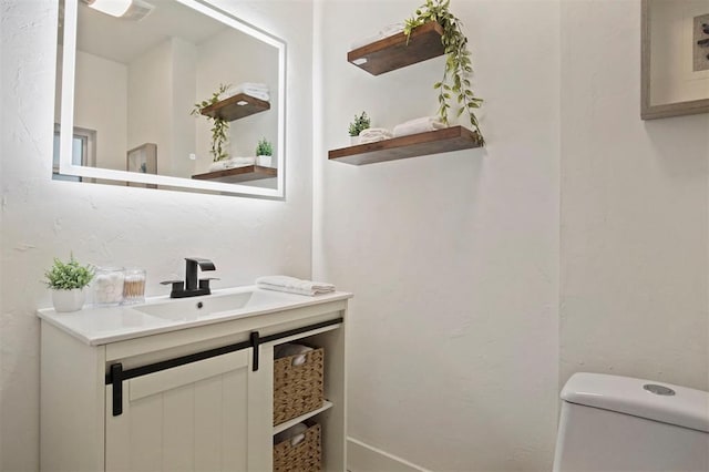 bathroom featuring vanity and toilet