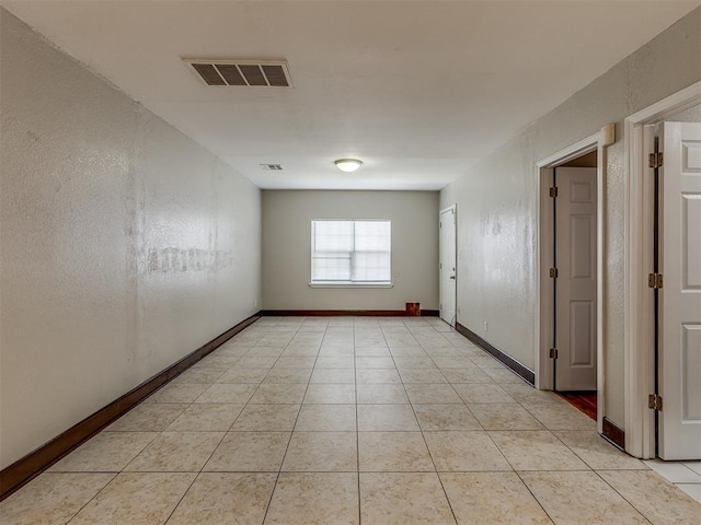 unfurnished room with light tile patterned flooring