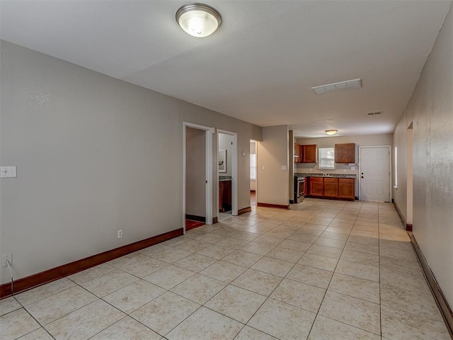 kitchen with stainless steel range and light tile patterned floors