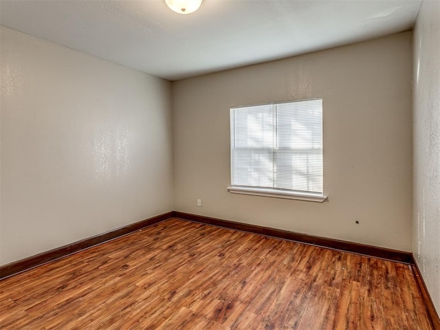 unfurnished room featuring hardwood / wood-style flooring