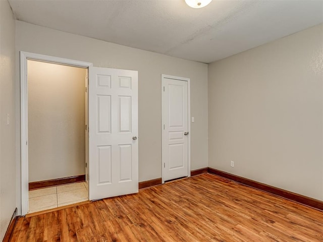 unfurnished bedroom featuring light wood-type flooring