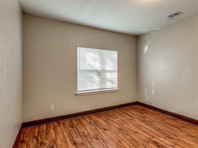 unfurnished room with hardwood / wood-style floors