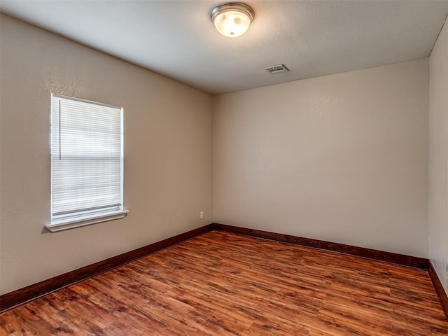 unfurnished room with hardwood / wood-style floors