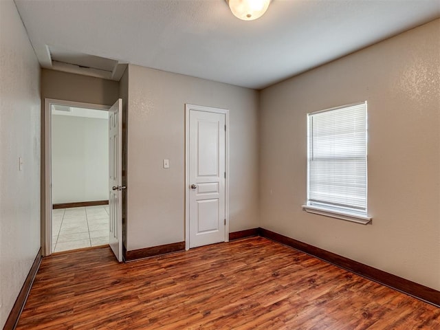 unfurnished bedroom featuring wood-type flooring and a closet