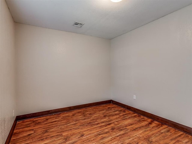 unfurnished room with hardwood / wood-style floors