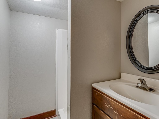 bathroom with vanity and a textured ceiling