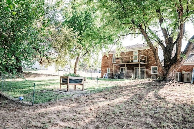 exterior space with brick siding and fence