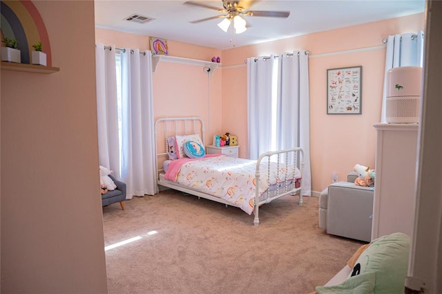 bedroom featuring light colored carpet, ceiling fan, and visible vents