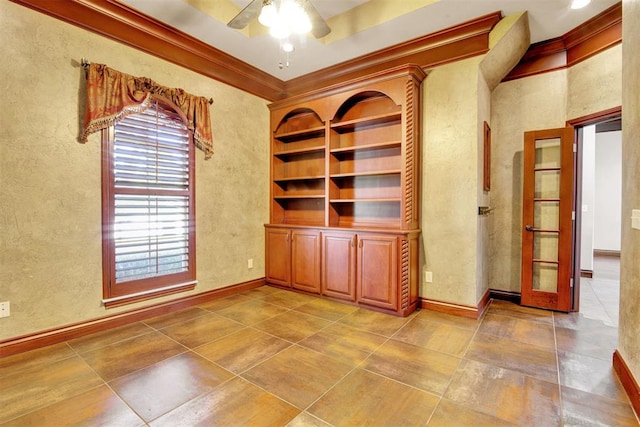 empty room featuring ceiling fan, ornamental molding, and french doors