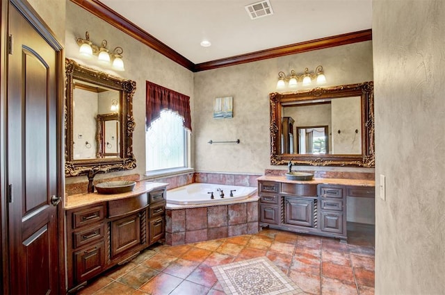 bathroom with vanity, crown molding, and tiled bath