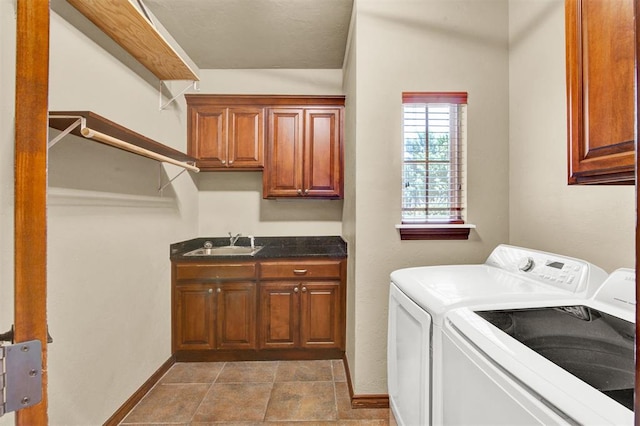 washroom with cabinets, separate washer and dryer, and sink