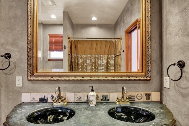 bathroom with a shower with shower curtain and sink