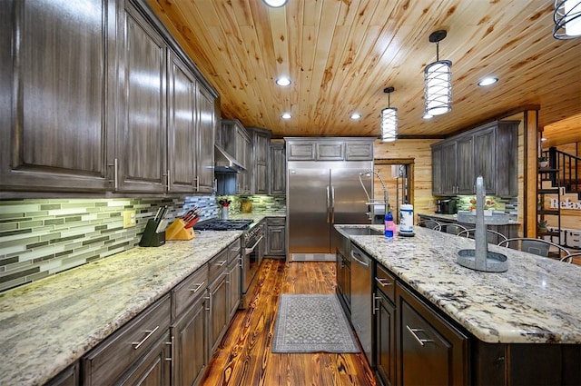 kitchen with dark brown cabinets, decorative light fixtures, high end appliances, and dark wood-type flooring