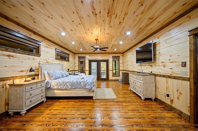 bedroom featuring wooden walls, dark wood-type flooring, and wooden ceiling