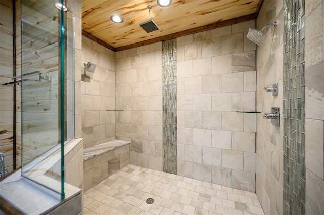 bathroom featuring a tile shower and wooden ceiling