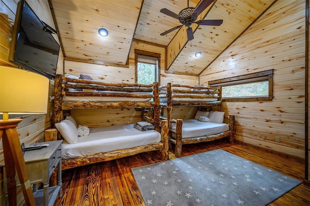 unfurnished bedroom featuring wooden ceiling, wooden walls, dark wood-type flooring, and lofted ceiling