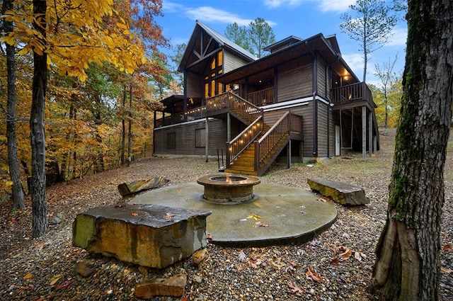 rear view of property with a wooden deck and a patio area