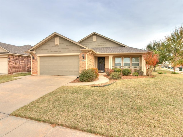 single story home with covered porch, a garage, and a front yard