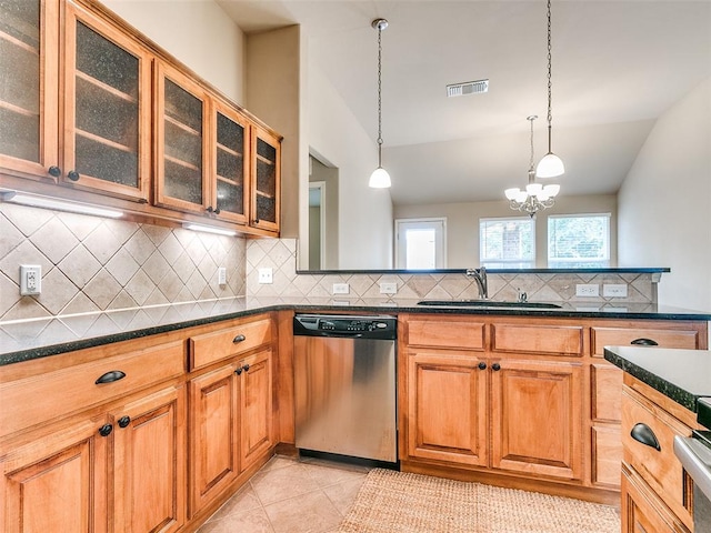 kitchen with a notable chandelier, dishwasher, sink, and hanging light fixtures