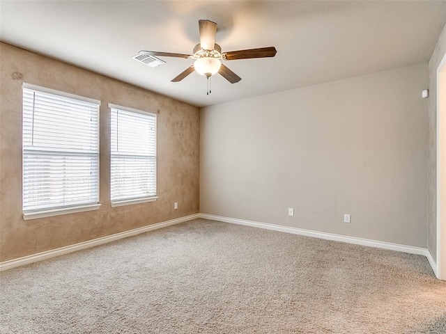 spare room featuring carpet flooring and ceiling fan