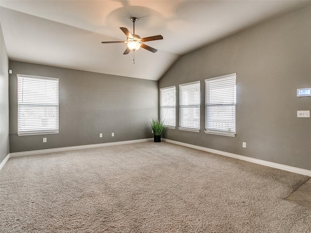 carpeted spare room with ceiling fan and lofted ceiling