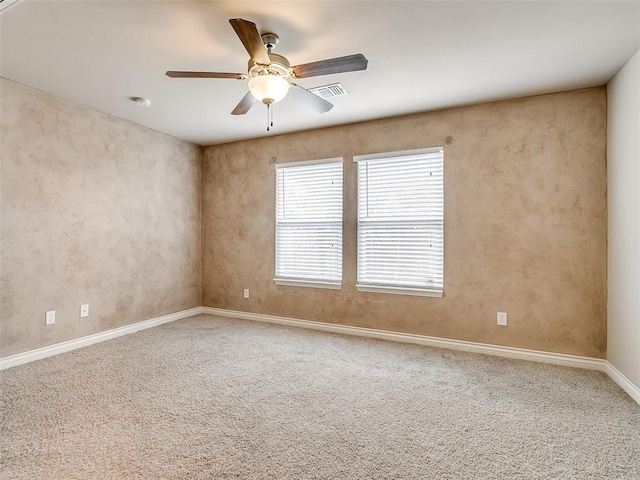 carpeted spare room featuring ceiling fan