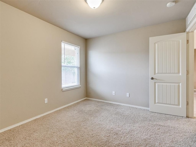 unfurnished room featuring carpet