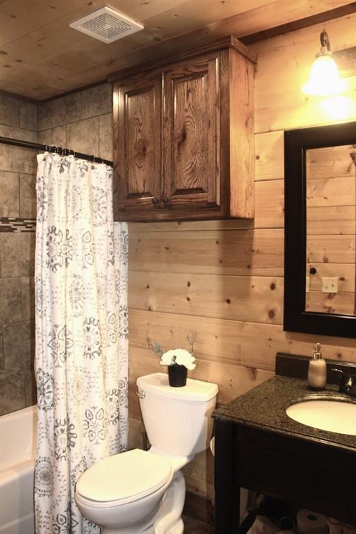 full bathroom with vanity, wood walls, toilet, and shower / bathtub combination with curtain