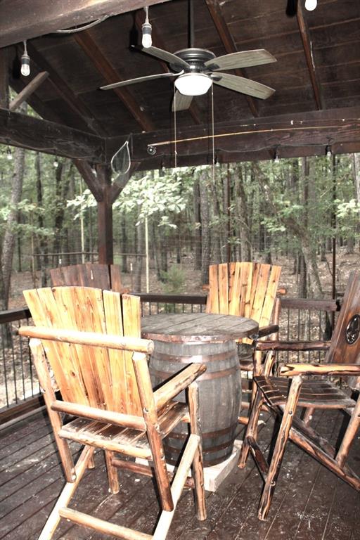 wooden terrace featuring ceiling fan