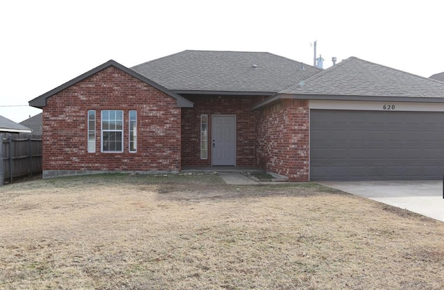 ranch-style home with a garage and a front lawn