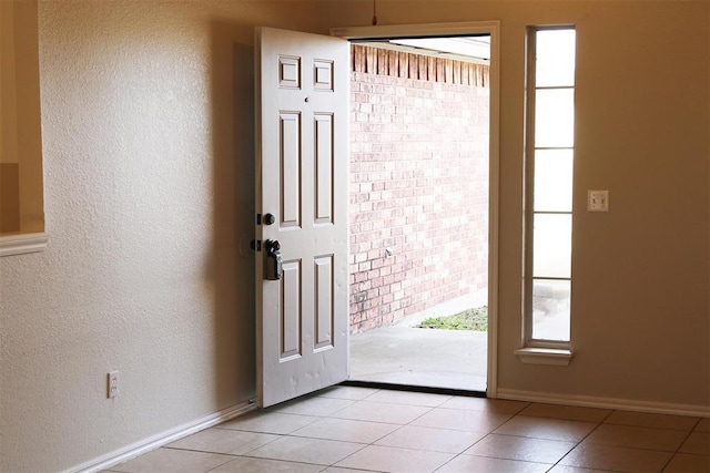 doorway featuring light tile patterned flooring