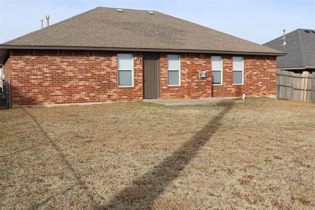 back of house featuring a patio and a lawn