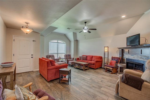 living room featuring a fireplace, wood-type flooring, ceiling fan, and lofted ceiling