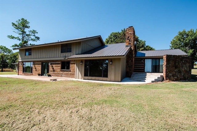 back of property featuring a yard and a patio area