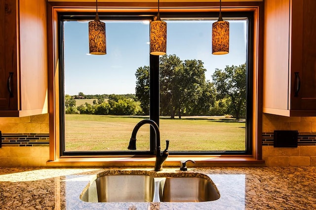 kitchen with a wealth of natural light, sink, and hanging light fixtures