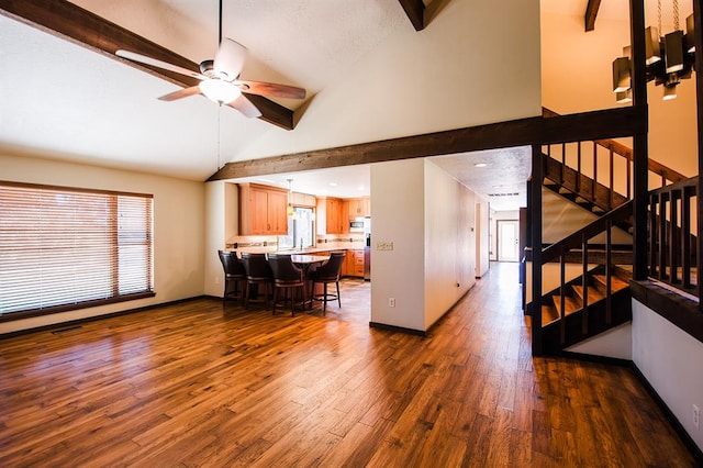 living room featuring beamed ceiling, dark hardwood / wood-style floors, ceiling fan, and high vaulted ceiling