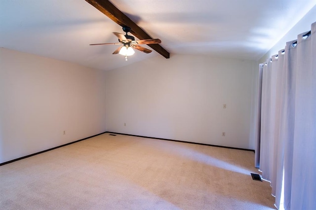 carpeted spare room featuring vaulted ceiling with beams and ceiling fan