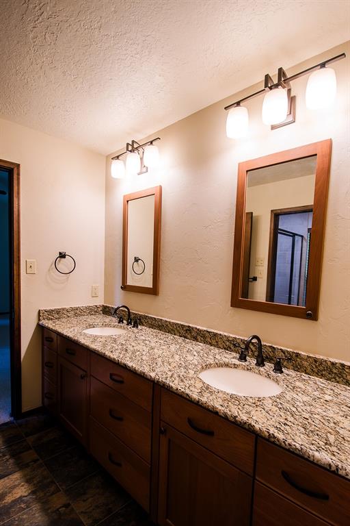 bathroom with vanity and a textured ceiling