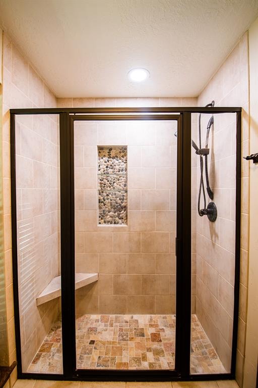 bathroom featuring an enclosed shower