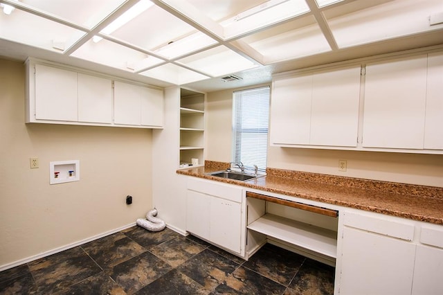 washroom featuring hookup for an electric dryer, cabinets, sink, and hookup for a washing machine