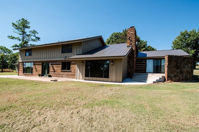 rear view of house with a yard and a patio area