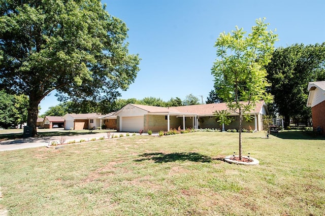 ranch-style home with a front yard and a garage