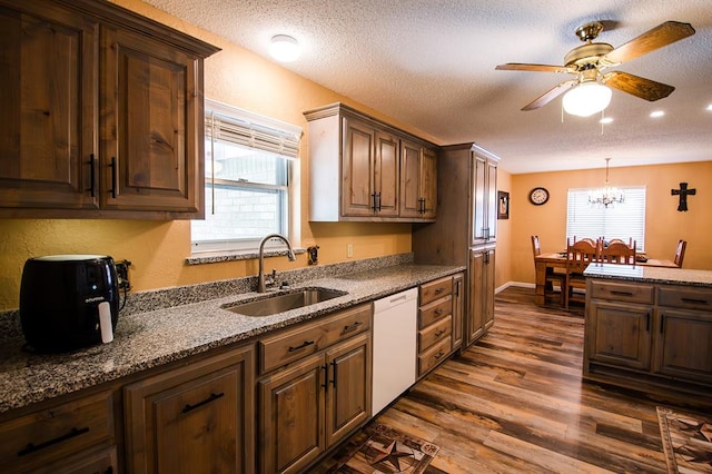 kitchen with dishwasher, a textured ceiling, dark wood-type flooring, and sink