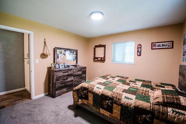 bedroom featuring carpet floors and a textured ceiling