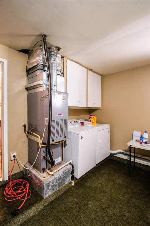 washroom featuring dark carpet, cabinets, and washing machine and clothes dryer