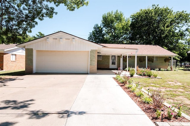 ranch-style house with a front yard, a garage, and covered porch