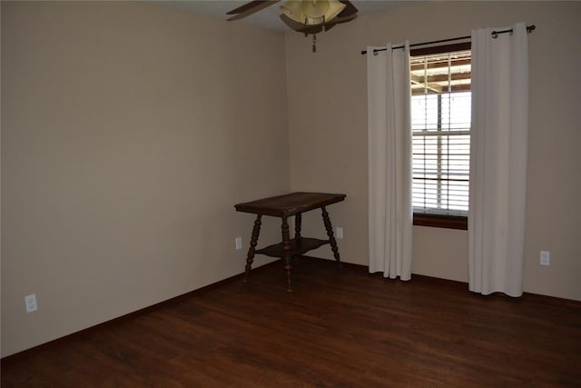 empty room with ceiling fan and dark hardwood / wood-style floors