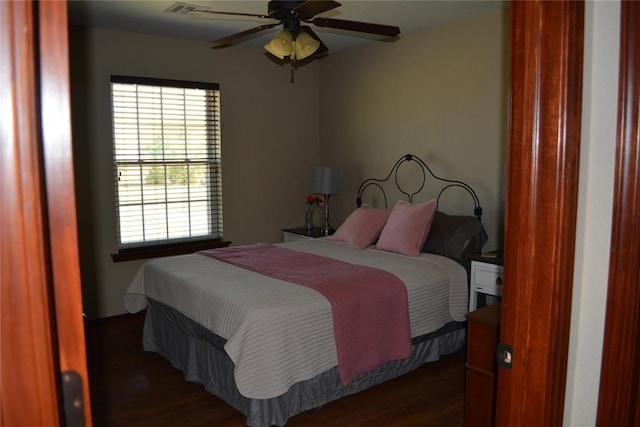 bedroom featuring ceiling fan and dark wood-type flooring